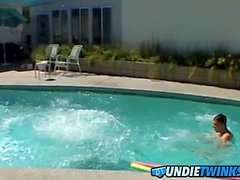 Handsome jock receives a handjob from his buddy by the pool